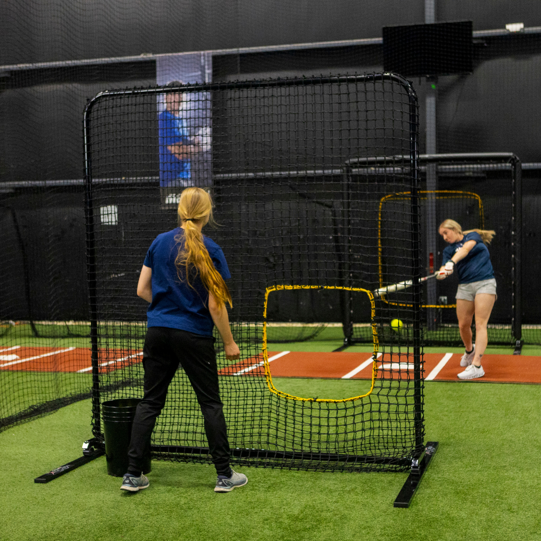 two softball players taking batting practice with web flex sports products