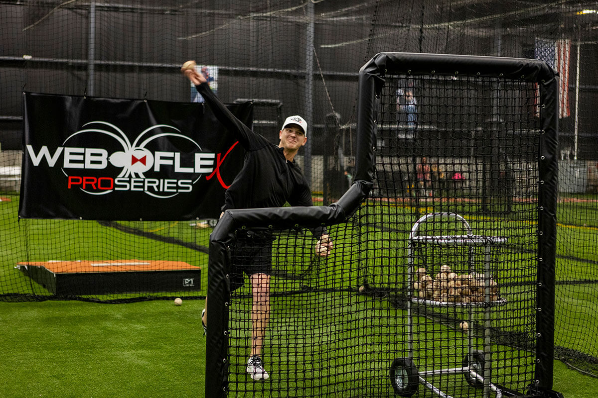 Parker Bridwell throwing batting practice behind a 7x7 L-Screen from web flex sports
